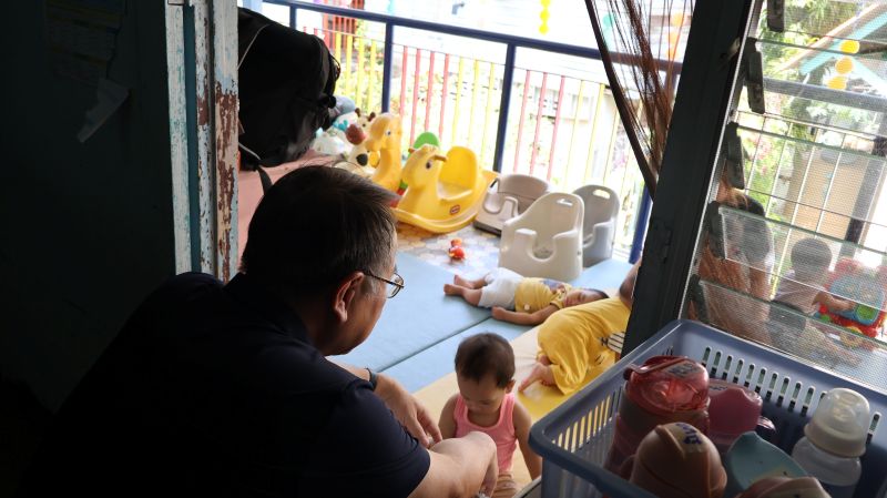 Picture 8: Mr. Piroon Laismit, Executive Director of APCD, looks at the children
