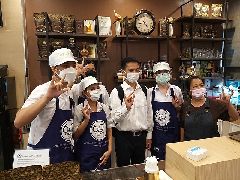 At the 60+ Plus Bakery and Chocolate Café, JOCVs posed for a group photo with staff and trainees.