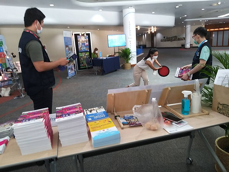 On the third day of the exhibition booth, Ms. Siriporn Praserdchat (Logistics Officer) and two of the neighboring exhibition booth members enjoy playing Dodge bee together in front of each other's booths.