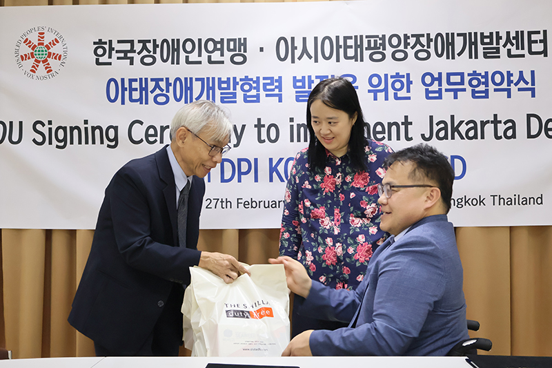 The MOU was signed by Mr. Lee Young Seok, President of DPI-Korea, along with Mr. Kim Eun Jung, Secretary-General, and Ms. Kim Eun Jung, Team Manager of International Relations. Representing APCD, Mr. Piroon Laismit, Executive Director, signed the MOU. Mr. Somchai Rungsilp, Manager of the Community Development Department, and Mr. Watcharapol Chuengcharoen, Chief of Networking & Collaboration, also reaffirmed the organization's commitment to the cause. The signing ceremony was attended by Mr. Taisuke Miyamoto, the representative of the Disabled People's International Asia-Pacific Region (DPI - AP), who witnessed this significant step toward advancing disability rights and inclusivity in the region. The Jakarta Declaration on the Asian and Pacific Decade of Persons with Disabilities, 2023–2032, underscores the importance of aligning national legislation with the Convention on the Rights of Persons with Disabilities, enhancing the participation of individuals with disabilities in decision-making processes, improving accessibility, mobilizing the private sector's resources to promote disability-inclusive development, and ensuring gender-responsive policies and programs for persons with disabilities. The declaration also emphasizes the need to close disability data gaps and strengthen capacities to monitor progress in disability-inclusive development.