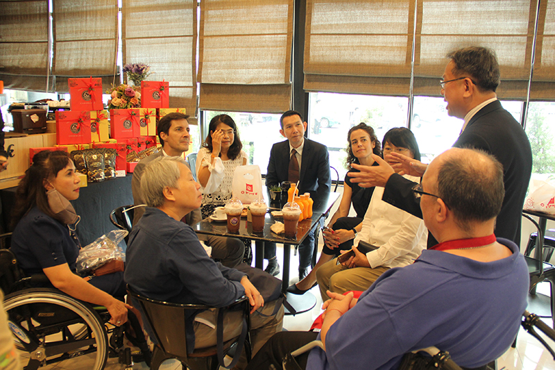 Mr. Piroon explained background of Disability-Inclusive Business to the visitors at 60+ Plus Bakery & Chocolate Café.