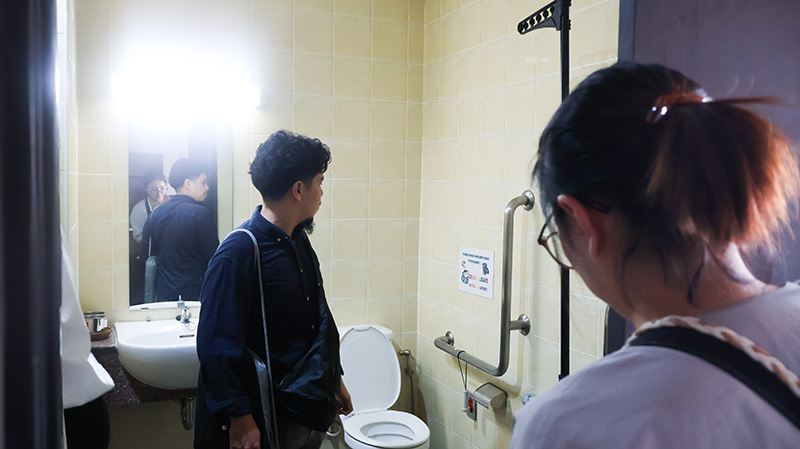 Picture 6: Mr. Thapanut Nookuea (left) and Ms. Jiyoung Kim (right) inspecting the accessible restroom facilities in the training building.