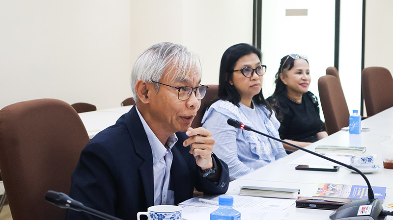 ภาพที่ 4: นายสมชาย รุ่งศิลป์ กำลังพูดผ่านไมโครฟอนที่โต๊ะประชุม โดยมี นางสาววิไลเลขา สมปราชญ์ และ นางสาวนงนุช เมธาจิตติพันธ์ นั่งอยู่ด้านหลัง