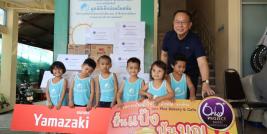 Picture 1: Mr. Piroon Laismit, Executive Director of APCD, poses for a group with the children