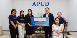 Picture 1: Participants pose for a group photo with a donation banner