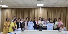 A group photo with Rhodes College and APCD, showcasing the souvenirs brought by the visitors.