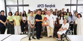 Picture 1: A group photo with Rhodes College and APCD, showcasing the souvenirs brought by the visitors.