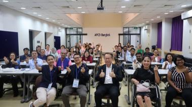 Participants pose for a group photo at the APCD training building.