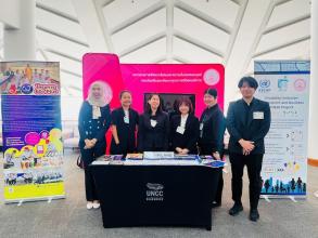 A group photo of APCD and DEP staff at the booth for UNESCAP Commission Session 82, capturing their strong spirit and active commitment in promoting DIEB.