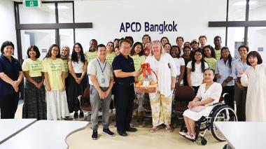 Picture 1: A group photo with Rhodes College and APCD, showcasing the souvenirs brought by the visitors.