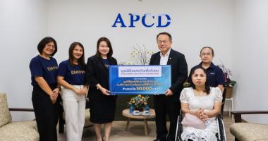 Picture 1: Participants pose for a group photo with a donation banner